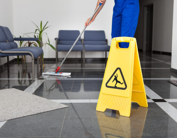 Man With Mop And Wet Floor Sign